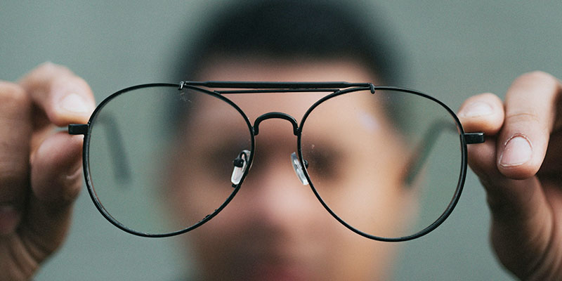 A man with glasses in front of his face